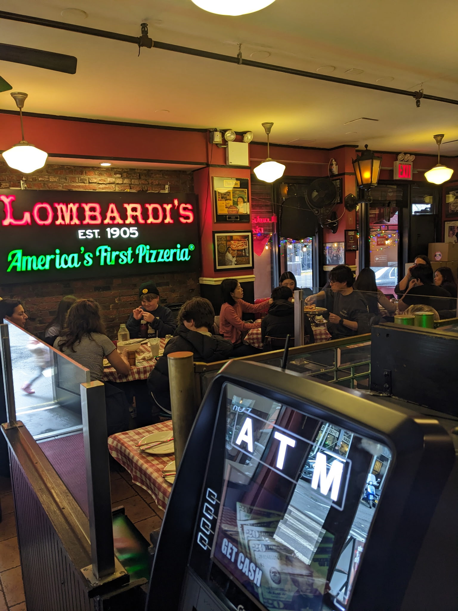 Lombardi's pizzeria interior dining with guests enjoying our famous pizza. 